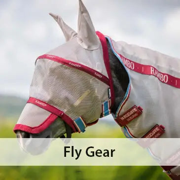 Horse wearing a fly mask with 'Rambo' branding in an outdoor setting
