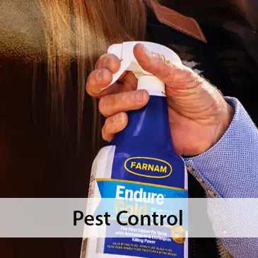 Person holding a Farnam Endure Pest Control spray bottle.